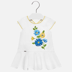 Mayoral Singapore Flower Embroidered Dress. This charming white cotton dress from Mayoral ticks all the boxes for holiday wear. Showcasing colorful embroidered florals, it also features delicate yellow trim around the armholes and the neckline. Add a pair of elegant sandals and a hat from the brand for a completed look. 